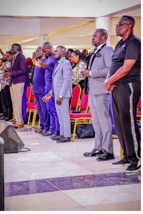 Men of Sound of Abundance Church standing in prayer
